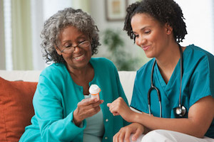 A home care worker showing medicine to a patient